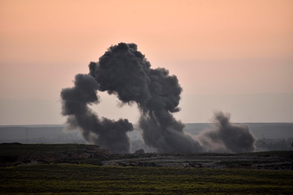 epa07381818 A general view showing smoke clouds rising following an alleged airstrike carried out by the international anti-Islamic State (IS) coalition in Baghouz town eastern Syria, on 19 February 2 ...