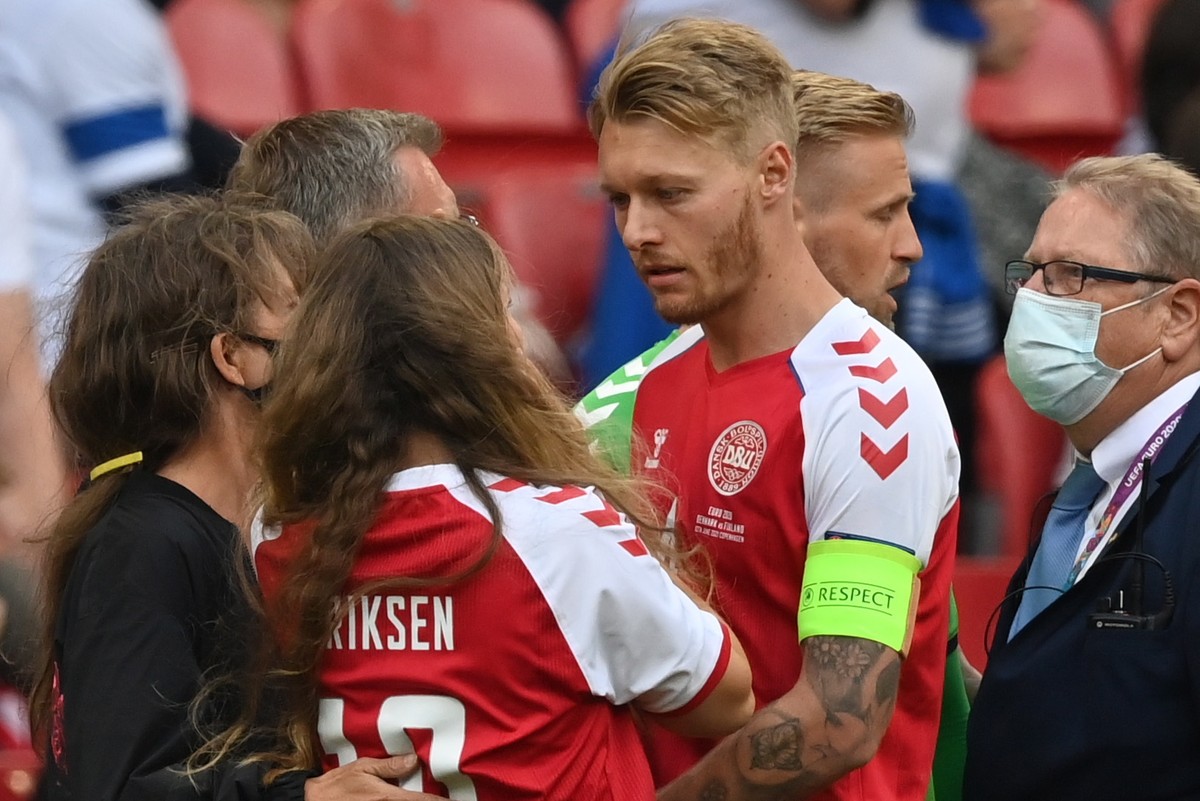 epa09265538 Sabrina Kvist Jensen (2-L), the girlfriend of Denmark's Christian Eriksen, is being consoled by Denmark's Simon Kjaer, during the UEFA EURO 2020 group B preliminary round soccer  ...