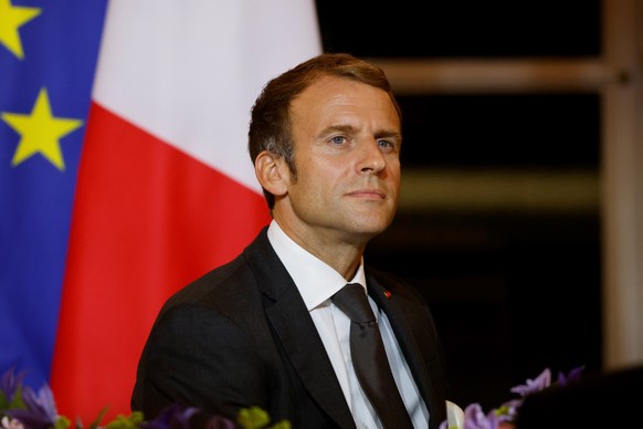 epa09498368 French President Emmanuel Macron reacts as he hosts a dinner at the Elysee Palace as part of the closing ceremony of the Africa2020 season, which presented the views of the civil society f ...