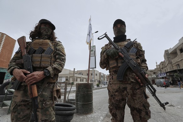 Syrian government security forces stand guard on their checkpointat one of Jaramana suburb entrances, after clashes in the area between members of the minority Druze sect and pro-government fighters,  ...