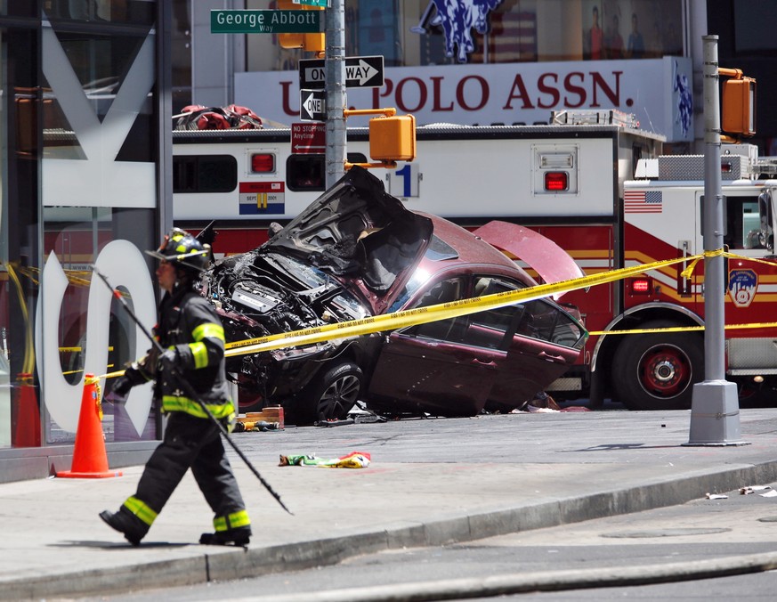 A smashed car sits on the corner of Broadway and 45th Street in New York&#039;s Times Square after ploughing through a crowd of pedestrians at lunchtime on Thursday, May 18, 2017. Police do not suspec ...