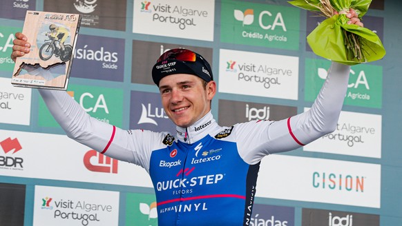 epa09772824 Belgian rider Remco Evenepoel of the Quick-Step Alpha Vinyl team celebrates on the podium after winning the fourth stage of the 48th Algarve Cycling Tour, a 32.2km time trial between Vila  ...