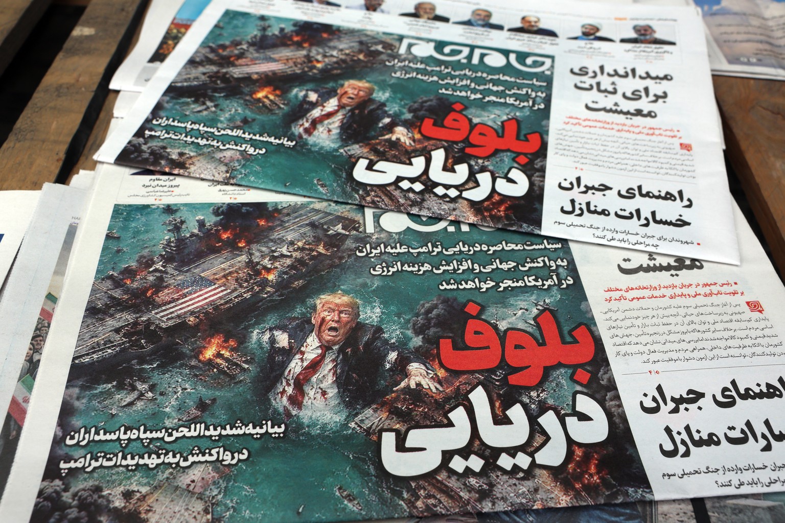 epa12886774 A stack of copies of the Iranian daily newspaper Jame Jam with the headline 'Sea Bluff' is displayed outside a kiosk in Tehran, Tehran, Iran, 13 April 2026. The conflict between  ...