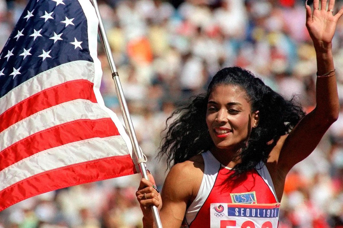 US sprinter Florence Griffith-Joyner waving with the "Stars and Stripes" after winning the Women's 100 meters sprint final of the 1988 Olympic Games in Seoul, September 25, 1988. Women& ...