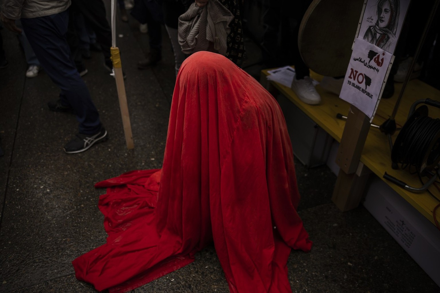 A woman performs during a protest against the death of Iranian Mahsa Amini, in Zurich, Switzerland, on Saturday October 1, 2022. Amini, a 22-year-old woman who died in Iran while in police custody, wa ...