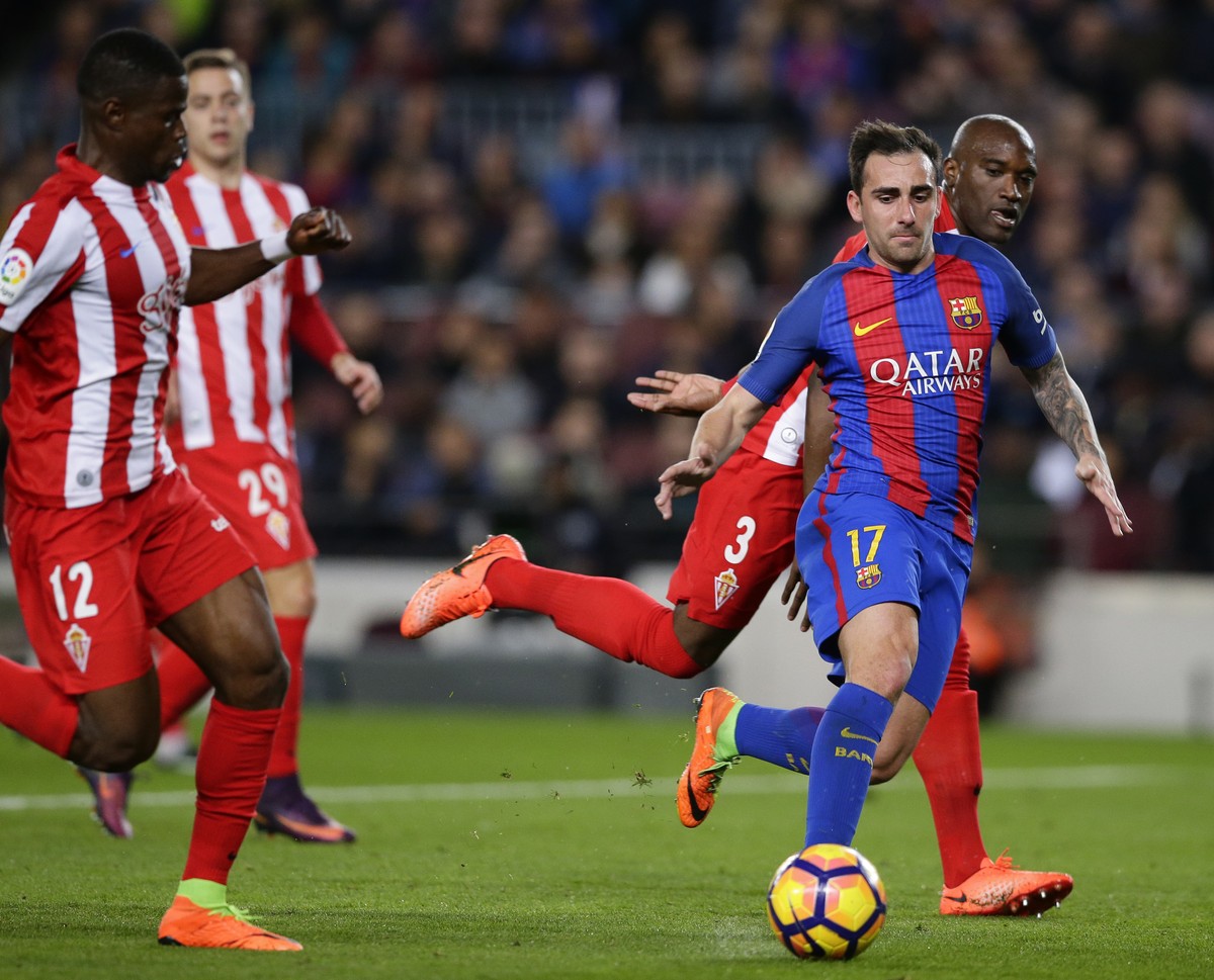 FC Barcelona's Paco Alcacer, right, duels for the ball during the Spanish La Liga soccer match between FC Barcelona and Sporting Gijon at the Camp Nou stadium in Barcelona, Spain, Wednesday, Marc ...