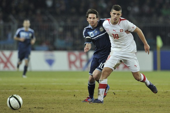 Switzerland's Granit Xhaka, right, fights for the ball against Argentina's Lionel Messi during a friendly soccer match between Switzerland and Argentina at the Stade de Suisse stadium in Ber ...