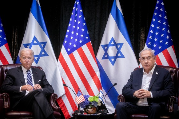 epa10925732 US President Joe Biden (L) looks on during a meeting with Israeli Prime Minister Benjamin Netanyahu (R) in Tel Aviv, Israel, 18 October 2023. President Biden pledged US support for Israel  ...