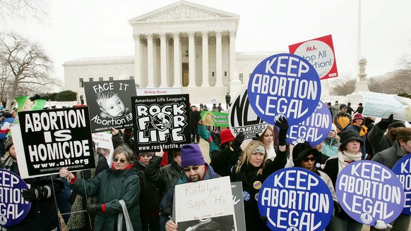 Anti-Abortion activists and Pro-Choice activists display their views in front of the Supreme Court during the Right For Life March arrives in Washington, DC Monday 24 January 2005. The Right For Life  ...