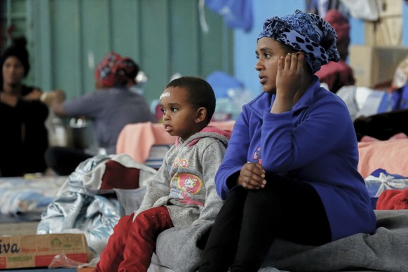 Migrants who fled fighting gather at a detention center in Zawya, Libya, west of Tripoli, on Saturday, April 27, 2019. Humanitarian organizations and international institutions are concerned about the ...