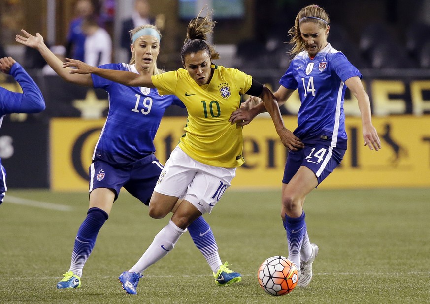 FILE- In this Oct. 21, 2015, file photo, Brazil&#039;s Marta (10) works to get to the ball between the United States&#039; Julie Johnston (19) and Morgan Brian (14) during the first half of an interna ...