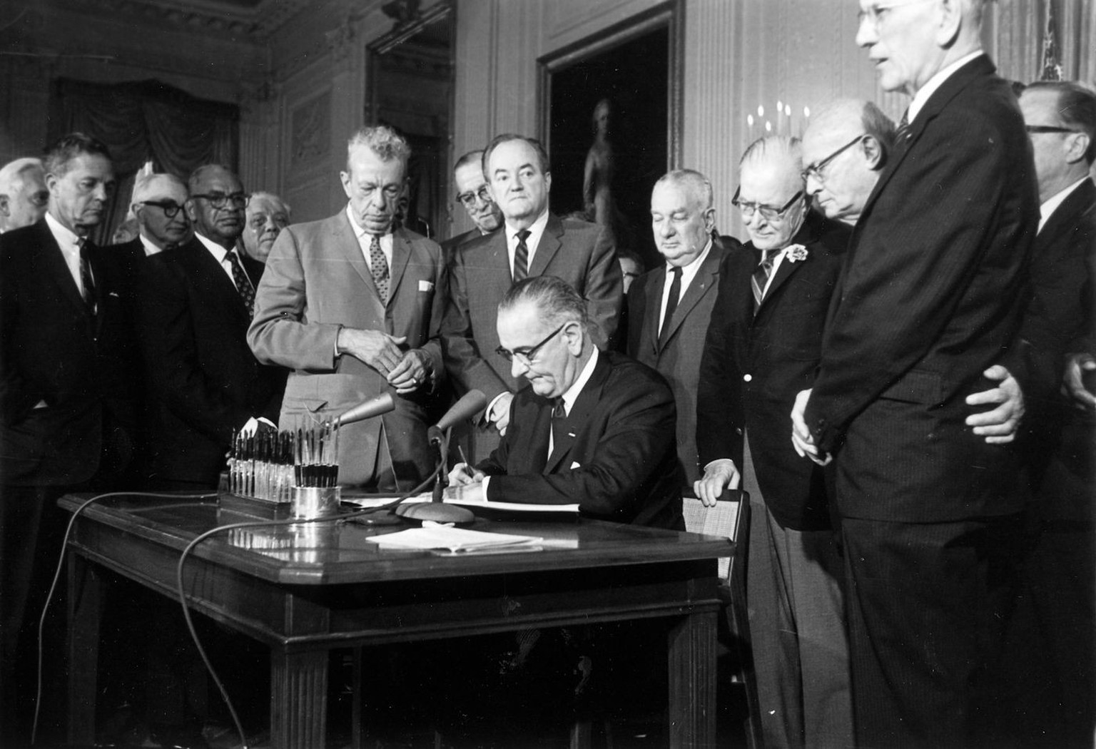 FILE - This July 2, 1964 file photo shows President Lyndon Baines Johnson signing the Civil Rights Act in the East Room of the White House in Washington. Standing, from left, are Sen. Everett Dirksen, ...