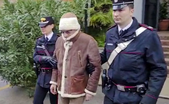 FILE - In this picture taken from a video released by Italian Carabinieri on Monday, Jan. 16, 2023, top Mafia boss Matteo Messina Denaro, center, leaves an Italian Carabinieri barrack soon after his a ...