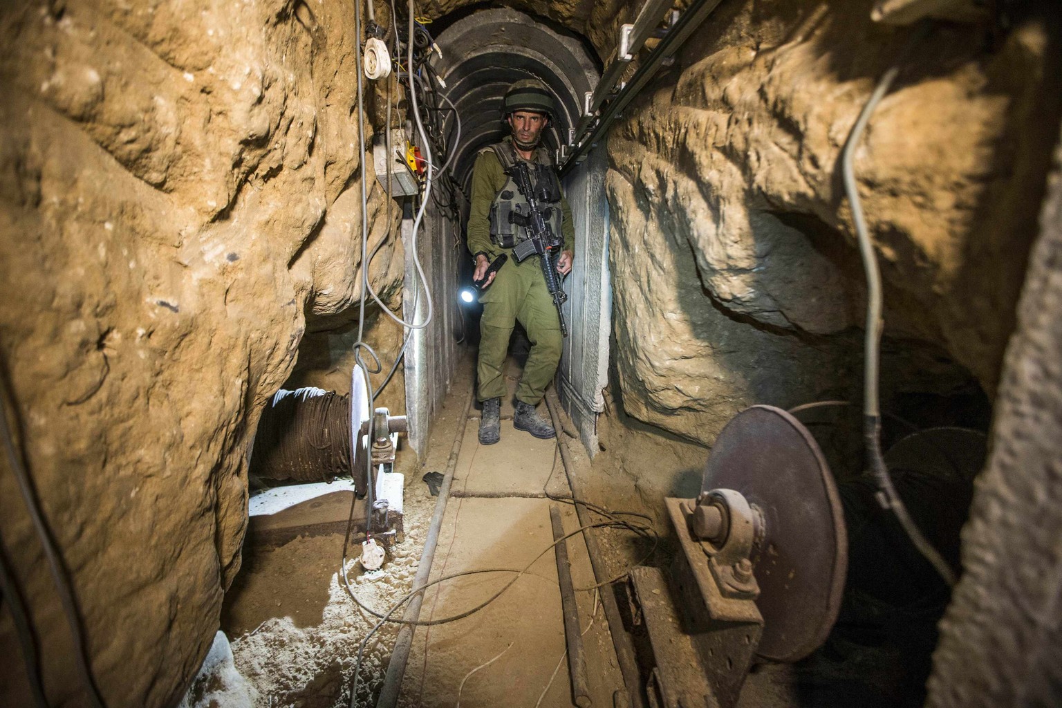 An Israeli army officer gives explanations to journalists during an army organised tour in a tunnel said to be used by Palestinian militants for cross-border attacks, July 25, 2014. U.S. Secretary of  ...
