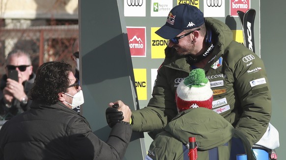 Former World Cup ski champion Alberto Tomba, left, congratulates Italy&#039;s Dominik Paris, right, at the finish area of an alpine ski, men&#039;s World Cup downhill race, in Bormio, Italy, Tuesday,  ...