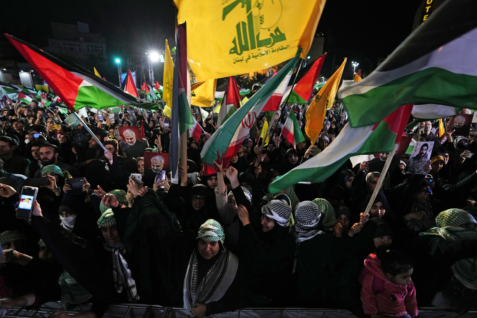 Iranian demonstrators wave Iranian, Palestinian and Lebanon&#039;s militant Hezbollah group flags in a pro-Palestinian rally at the Felestin (Palestine) Sq. in Tehran, Iran, Friday, Oct. 20, 2023. (AP ...