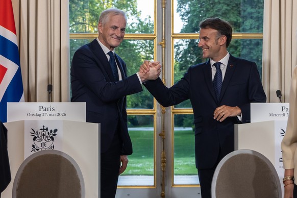France's President Emmanuel Macron, right, and Norway's Prime Minister Jonas Gahr Store shake hands during a joint news conference at the Elysee Palace in Paris, France, Wednesday, May 27, 2 ...