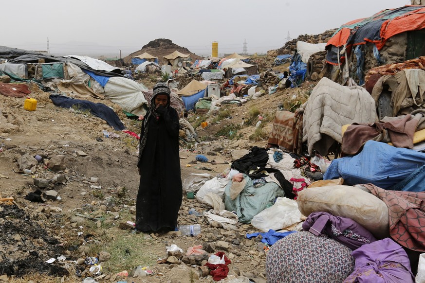 epa07727842 A displaced Yemeni woman walks through a camp for Internally Displaced Persons (IDPs) on the outskirts of Sana&#039;a, Yemen, 19 July 2019. According to reports, the World Food Programme ( ...