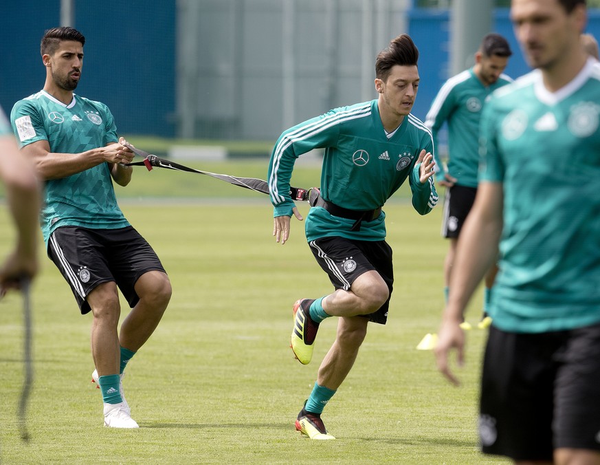 FILE - In this file photo from June 14, 2018, Mesut Ozil runs followed by Sami Khedira during a training session of the German team at the 2018 soccer World Cup in Vatutinki near Moscow. (AP Photo/Mic ...