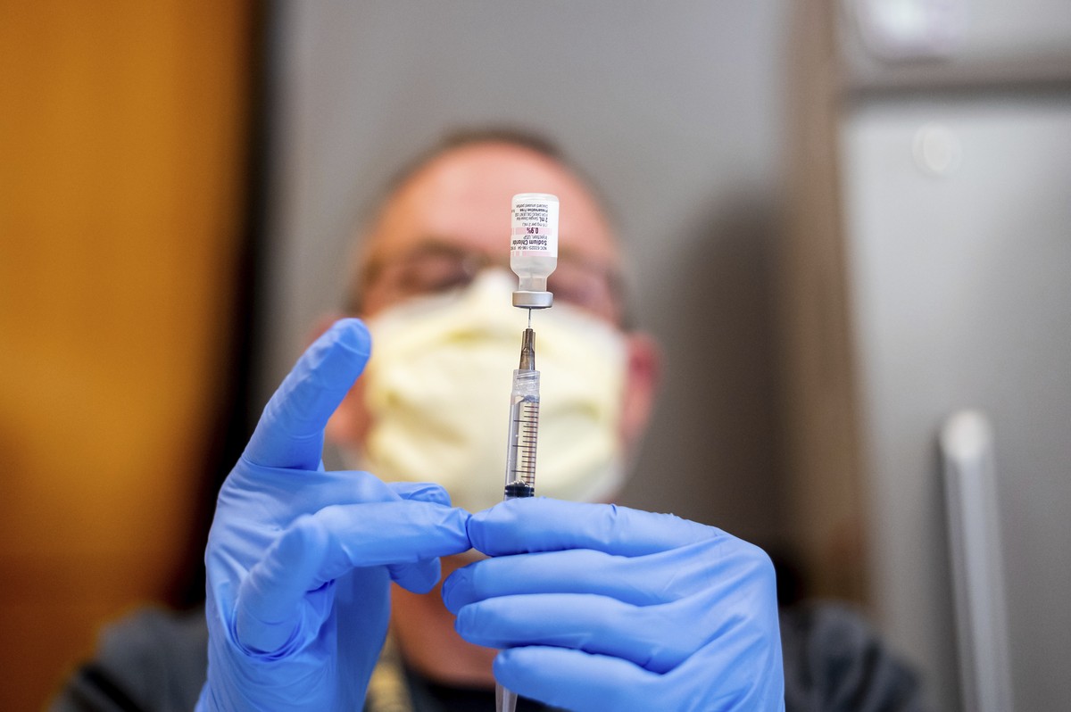 FILE - In this Jan. 12, 2021, file photo Pharmacist Brian Kiefer draws saline while preparing a dose of Pfizer's COVID-19 vaccine at UC Davis Health in Sacramento, Calif. With demand for the coro ...