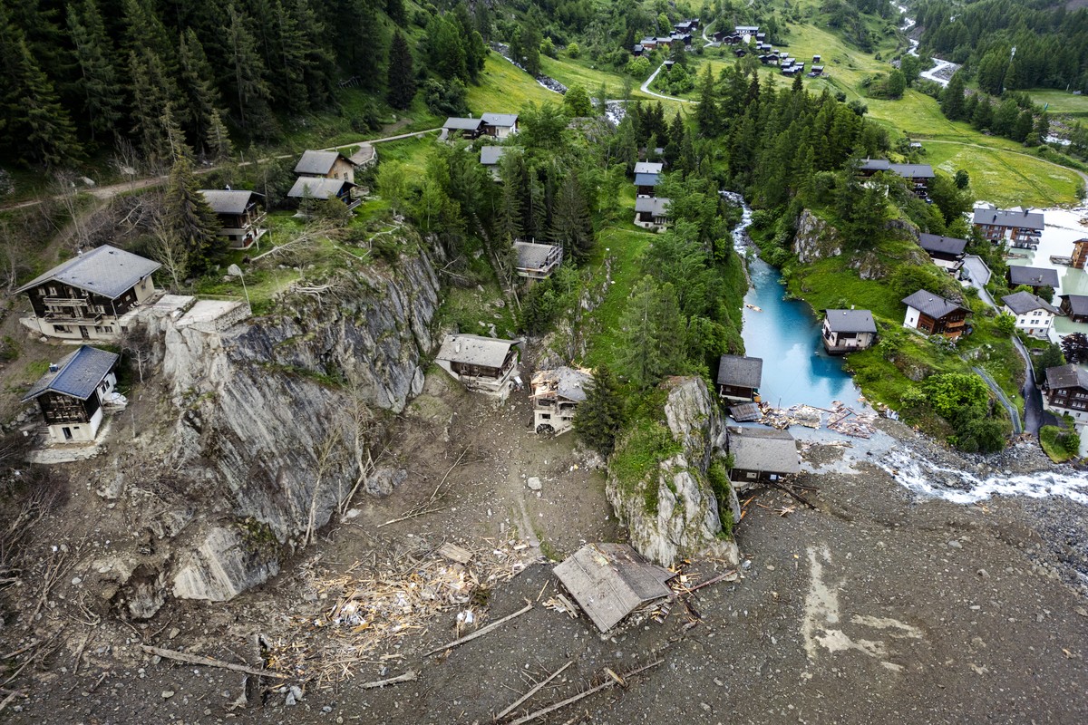 epa12160022 An aerial view shows houses devastated by the force of a massive avalanche triggered by the collapse of the Birch Glacier, which swept down to the valley floor and destroyed the village of ...