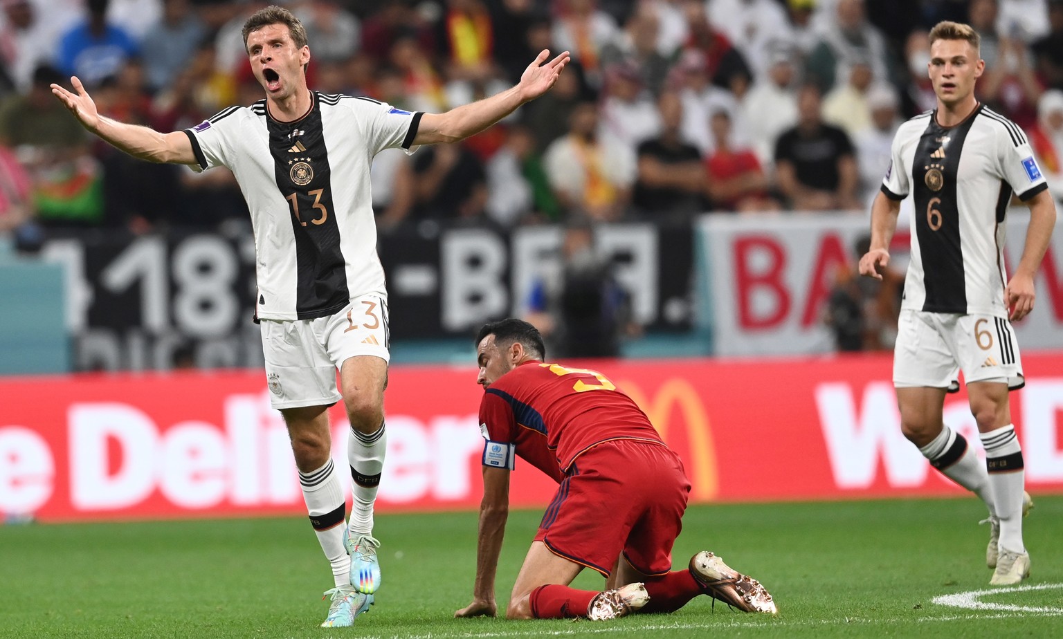epa10333209 Thomas Mueller (L) of Germany reacts during the FIFA World Cup 2022 group E soccer match between Spain and Germany at Al Bayt Stadium in Al Khor, Qatar, 27 November 2022. EPA/Georgi Licovs ...