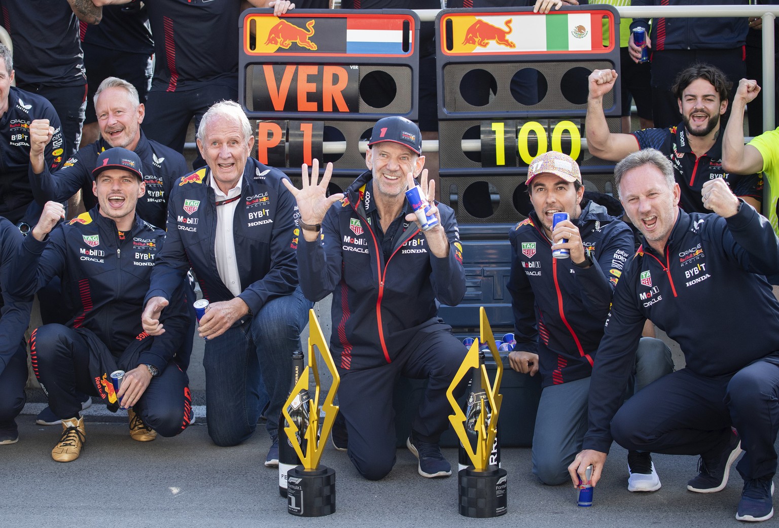 Team Red Bull, including drivers Max Verstappen, front left, of the Netherlands; Sergio Perez, second from front right, of Mexico; and team principle Christian Horner, right; celebrate the team&#039;s ...
