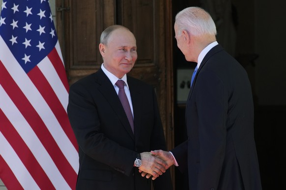 epa09275808 US President Joe Biden (R) and Russian President Vladimir Putin (L) shake hands during the US-Russia summit at the Villa La Grange, in Geneva, Switzerland, 16 June 2021. EPA/ALEXANDER ZEML ...