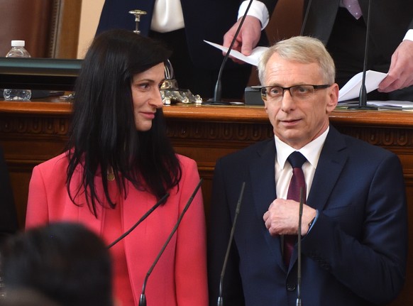 epa10675948 The new Prime Minister Nikolay Denkov (R) and the new Minister of Foreign Affairs Mariya Gabriel (L) after taking the oath at the Parliament in Sofia, Bulgaria, 06 June 2023. The two large ...