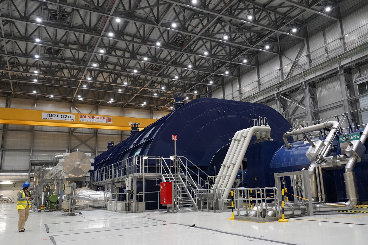 A member of the media stands in the turbine hall of Olkiluoto 3 (OL3), Europe's largest nuclear reactor, during a press tour on the island of Olkiluoto, Finland, Tuesday, Feb. 24, 2026. (AP Photo ...