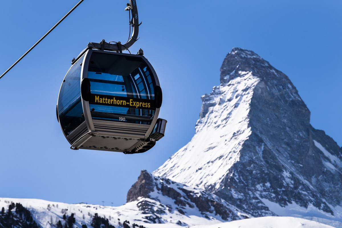 FILE - A 'Matterhorn-Express' gondola lift in front of Matterhorn mountain in the Zermatt ski resort, in Zermatt, Switzerland, March 18, 2020. Skiing���s newest downhill course that crosses  ...