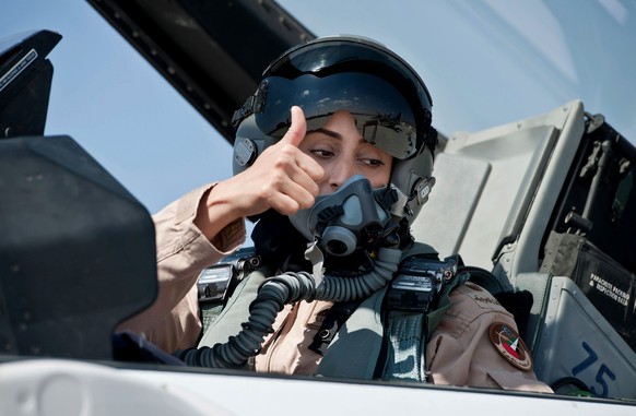 This June 13, 2013 photo provided by the Emirates News Agency, WAM, shows Mariam al-Mansouri, the first Emirati female fighter jet pilot gives the thumbs up as she sits in the cockpit of an aircraft,  ...