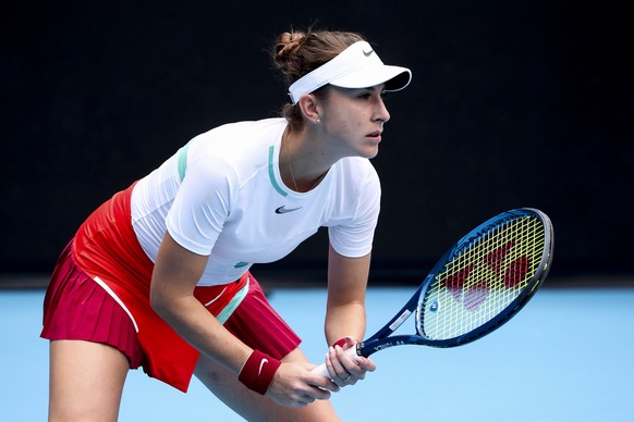 epa09690165 Belinda Bencic of Switzerland in action against Kristina Mladenovic of France during their first round match at the Australian Open Grand Slam tennis tournament in Melbourne, Australia, 17 ...