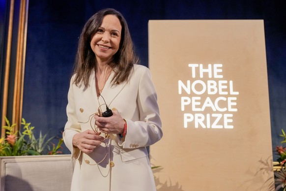 epa12584826 Nobel Peace Prize laureate Maria Corina Machado, accompanied by the head of the Nobel Committee Jorgen Watne Frydnes (not pictured) and the director of the Norwegian Nobel Institute Kristi ...