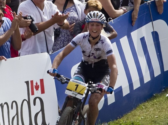 Jolanda Neff, of Switzerland, smiles after finishing the UCI women&#039;s cross country world cup on Sunday, Aug. 3, 2014, at the UCI mountain bike world cup at Mont-Sainte-Anne in Beaupre, Quebec. Ne ...