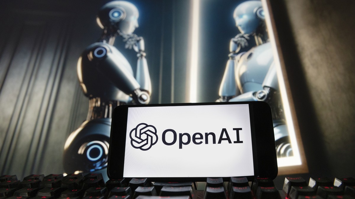 FILE - The OpenAI logo is displayed on a cellphone with an image on a computer monitor generated by ChatGPT's Dall-E text-to-image model, Dec. 8, 2023, in Boston. Hong Kong?s government is testin ...