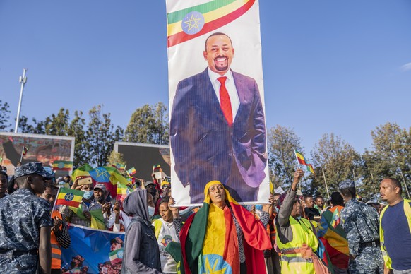 epa09569390 Ethiopians carry a poster of president Abiy Ahmed as they attend a rally held to show support for the government and the Ethiopian National Defense Force (ENDF), in their effots against th ...