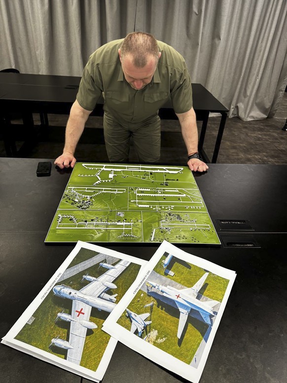 epa12149679 A handout photo made available by the Ukrainian Security Service (SSU) Telegram Channel on 01 June 2025 shows the head of the Security Service Vasyl Malyuk, studying a photo of a map of Ru ...