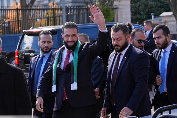 Syria&#039;s President Ahmed al-Sharaa waves as he greets supporters outside of the White House, Monday, Nov. 10, 2025, in Washington, following a meeting with President Donald Trump. (AP Photo/Jacque ...