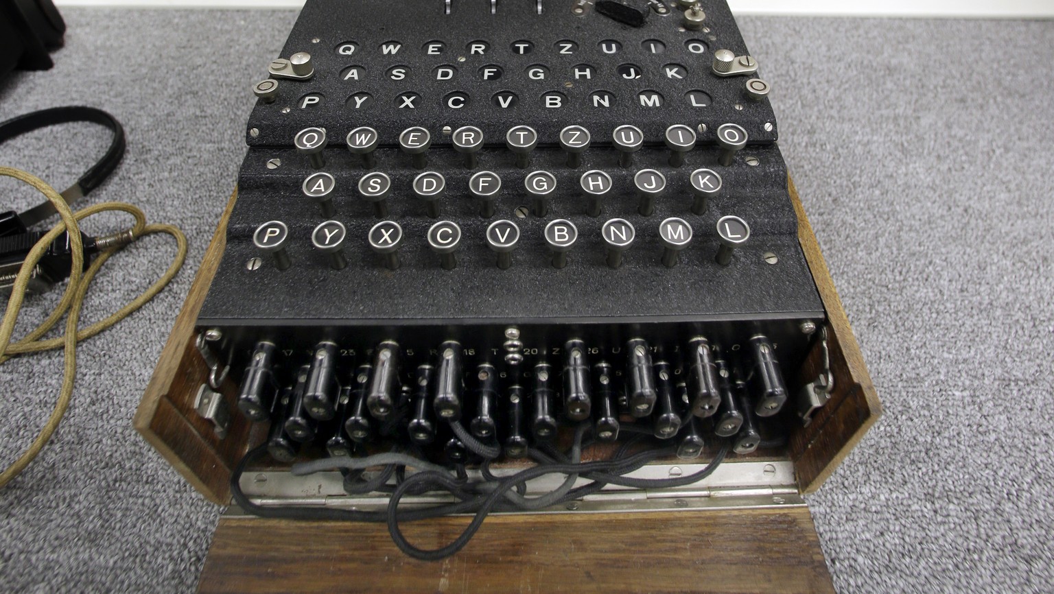 A Nazi Enigma encryption machine is displayed at the World War II Museum in Natick, Mass., Wednesday, Feb. 18, 2015. In the Oscar-nominated film "The Imitation Game," Benedict Cumberbatch le ...