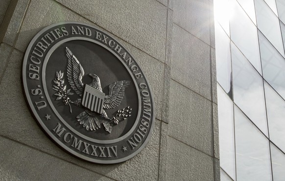 FILE - The seal of the U.S. Securities and Exchange Commission at SEC headquarters in Washington is seen, June 19, 2015. A bipartisan group of more than a two dozen lawmakers are asking the SEC to put ...