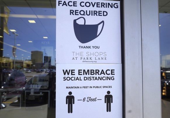 Signs tells customers about safety measures against COVID-19 that are required inside a retail store Tuesday, March 2, 2021, in Dallas. Texas is lifting a COVID-19 mask mandate that was imposed last s ...