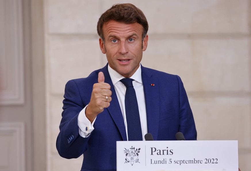 epa10161779 France's President Emmanuel Macron addresses the media following a conference with Germany's Chancellor Olaf Scholz (not pictured) on the energy crisis via video link, at the Elysee presid ...