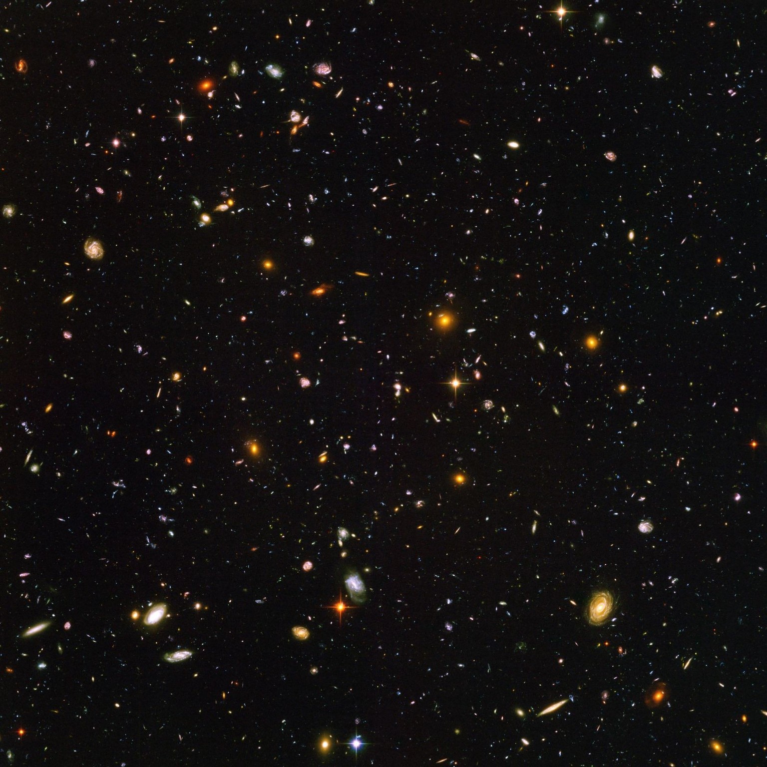 This view of nearly 10,000 galaxies is called the Hubble Ultra Deep Field. The snapshot includes galaxies of various ages, sizes, shapes, and colours. The smallest, reddest galaxies, about 100, may be ...