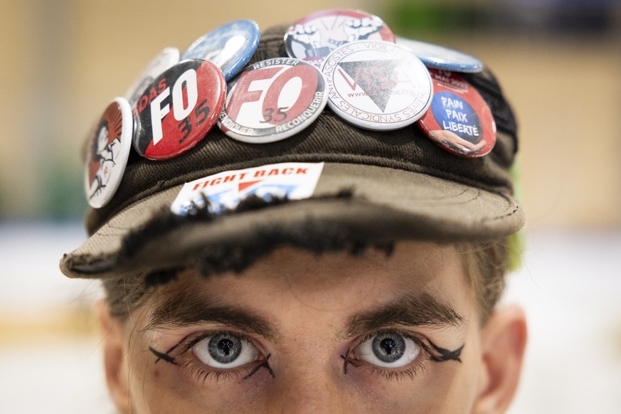 epa10755287 Bookseller Elo poses at the book fair during the international anti-authoritarian rally Anarchy 2023 in St-Imier, Switzerland, on Wednesday, July 19, 2023. The rally will take place v...