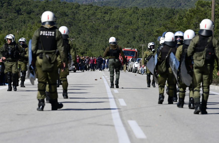 Riot police block the protesters during a rally in Diavolorema near the area where the government plans to build a new migrant detention center, on the northeastern Aegean island of Lesbos, Greece, Tu ...