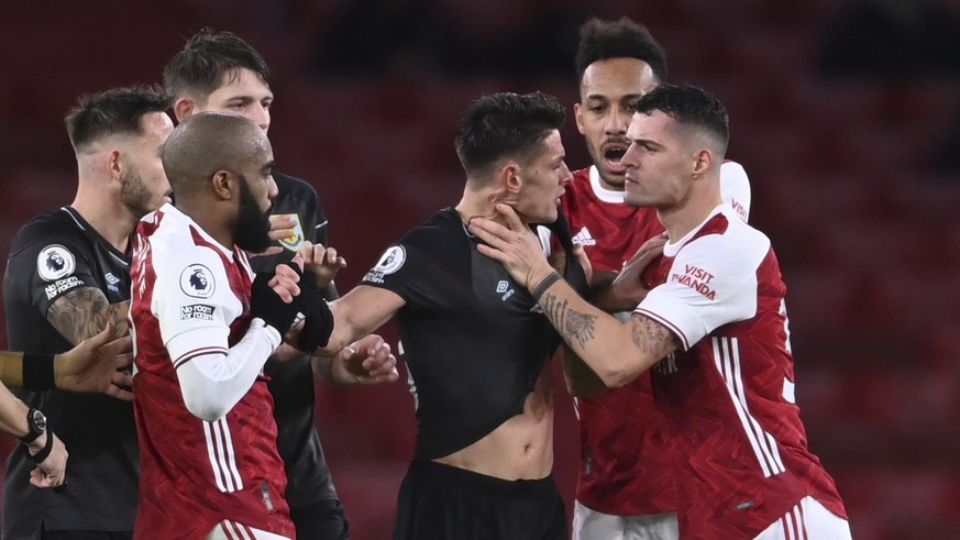 epa08882684 Granit Xhaka (R) of Arsenal fights with Ashley Westwood (3-R) of Burnley during the English Premier League soccer match between Arsenal FC and Burnley FC in London, Britain, 13 December 20 ...