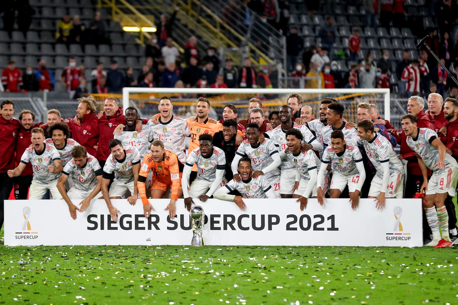 epa09418364 The team of Bayern Munich celebrates with the trophy following the DFL Supercup 2021 soccer match between Borussia Dortmund and FC Bayern Muenchen in Dortmund, Germany, 17 August 2021. EPA ...