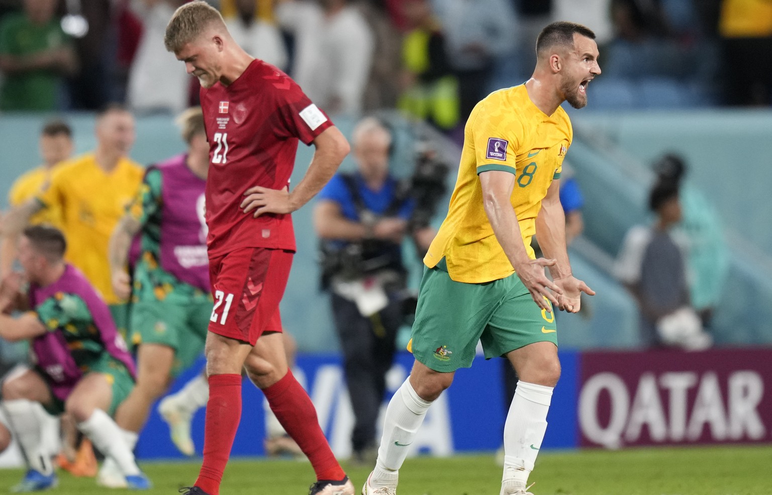 Denmark&#039;s Andreas Cornelius, left, is dejected as Australia&#039;s Bailey Wright celebrates after the World Cup group D soccer match between Australia and Denmark, at the Al Janoub Stadium in Al  ...