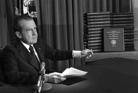 FILE - In this April 29, 1974, file photo, President Richard M. Nixon points to the transcripts of the White House tapes after he announced during a nationally-televised speech that he would turn over ...